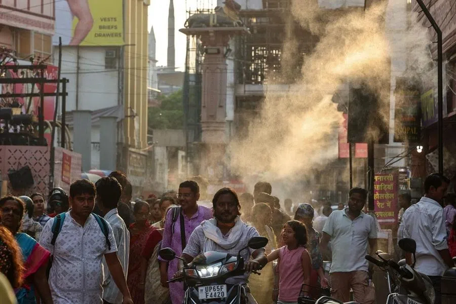 People walk along a street in Varanasi, India, on 15 May 2026.