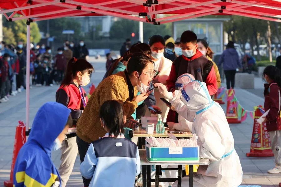 This photo taken on 19 October 2022 shows a woman undergoing a nucleic acid test for the Covid-19 coronavirus in Lianyungang in China's eastern Jiangsu province. (AFP)