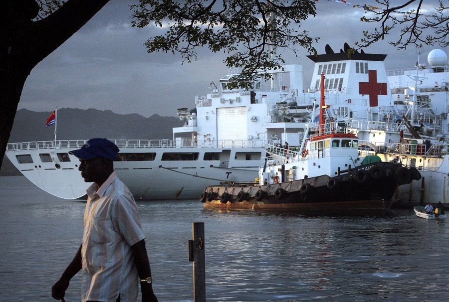 A man walks past a Chinese hospital ship called The Peace Ark, moored in the harbour of the Fiji capital of Suva, 24 August 2014. (Lincoln Feast/File Photo/Reuters)