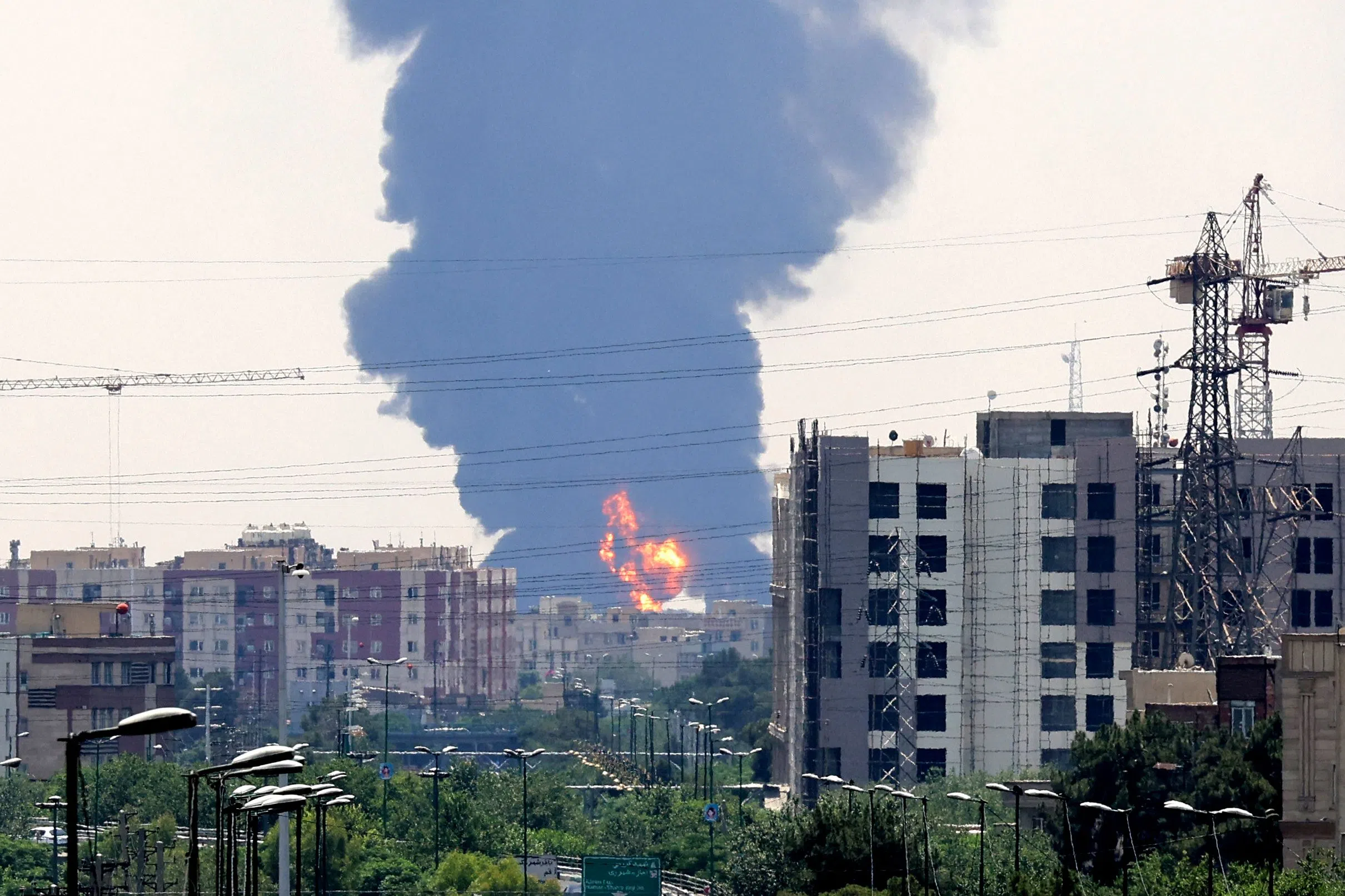 A plume of heavy smoke and fire rise from an oil refinery in southern Tehran, after it was hit in an overnight Israeli strike, on 15 June 2025. (Atta Kenare/AFP)