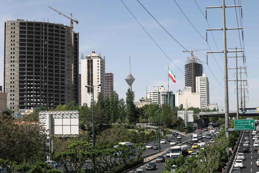 Cars drive on a highway with the Milad Tower in the background in the capital Tehran, on 12 April 2021. (Atta Kenare/AFP)
