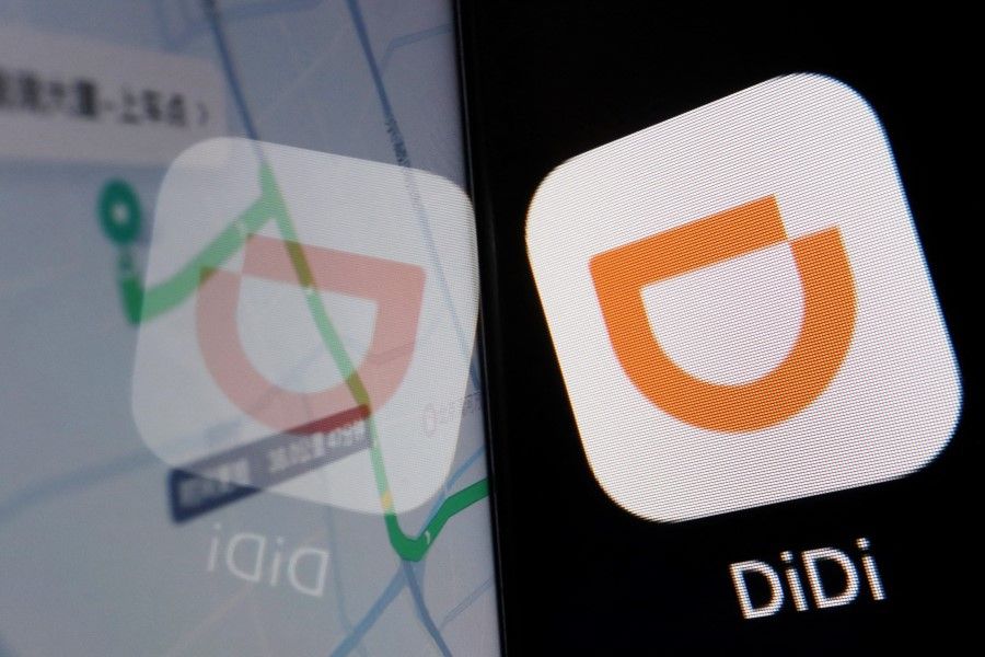 The app logo of Chinese ride-hailing giant Didi is seen reflected on its navigation map displayed on a mobile phone in this illustration picture taken 1 July 2021. (Florence Lo/Reuters)