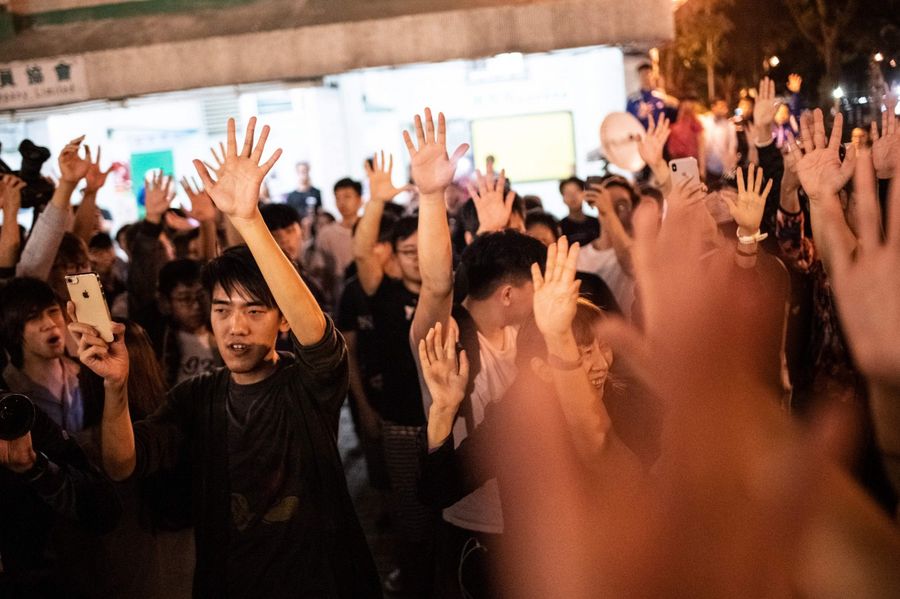 Pro-democracy supporters celebrate after pro-Beijing candidate Junius Ho lost a seat in the district council elections in Tuen Mun district of Hong Kong, early on November 25, 2019. (Philip Fong/AFP)