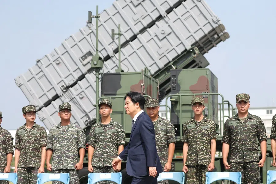 Taiwanese President Lai Ching-te walks past soldiers at a naval base following a Chinese military drills earlier in the week in Taoyuan on 18 October 2024.