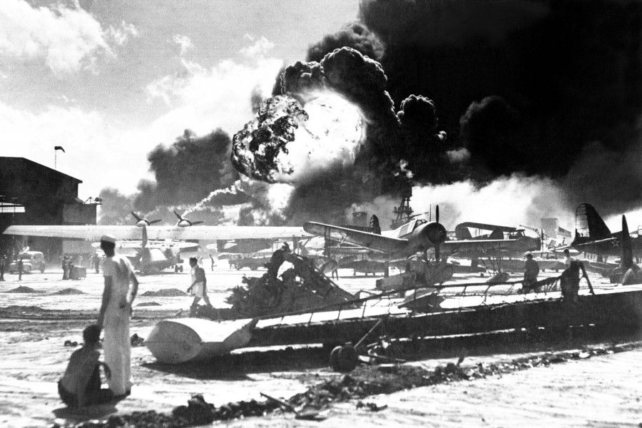 The Japanese attack on Pearl Harbor, 7 December 1941, is pictured in this historic US Navy photograph. In the distance, the smoke rises from Hickam Field. (US Navy)