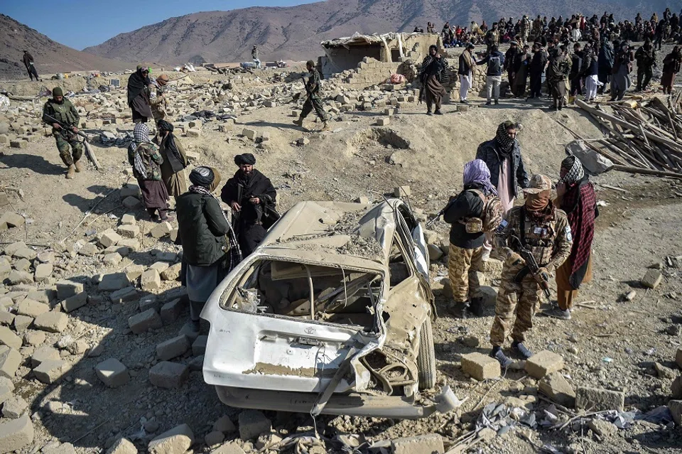 Taliban security personnel inspect a damaged car two days after air strikes by Pakistan in the Barmal district of eastern Paktika province on 26 December 2024. (Ahmad Sahel Arman/AFP)