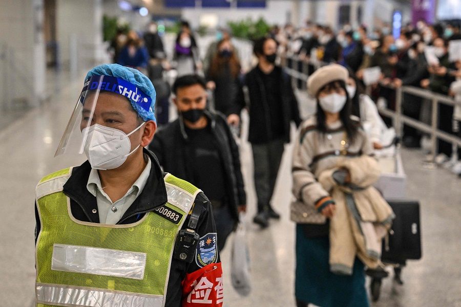 Passengers are seen upon their arrival at the Shanghai Pudong International Airport in Shanghai, China, on 8 January 2023. (Hector Retamal/AFP)