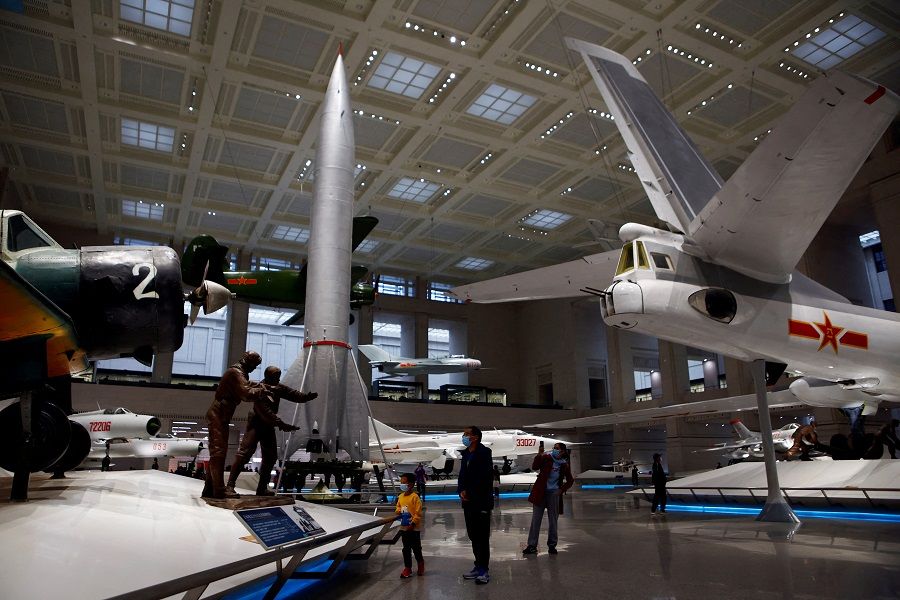 Visitors look at displays of military aircraft and a ground-to-ground missile at the Military Museum of the Chinese People's Revolution in Beijing, China, 8 October 2022. (Florence Lo/File Photo/Reuters)