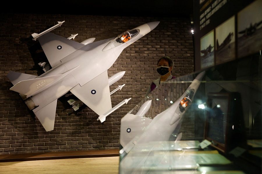 A staff member walks next to a scale model of an IDF (Ching-Kuo Fighter) jet during a Defence Ministry-organised media visit to the National Chung-Shan Institute of Science and Technology in Taichung, Taiwan, 15 November 2022. (Carlos Garcia Rawlins/Reuters)