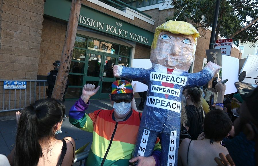 A protester holds a piñata of US President Donald Trump during a demonstration in honor of George Floyd on 3 June 2020 in San Francisco, California. (Justin Sullivan/Getty Images/AFP)