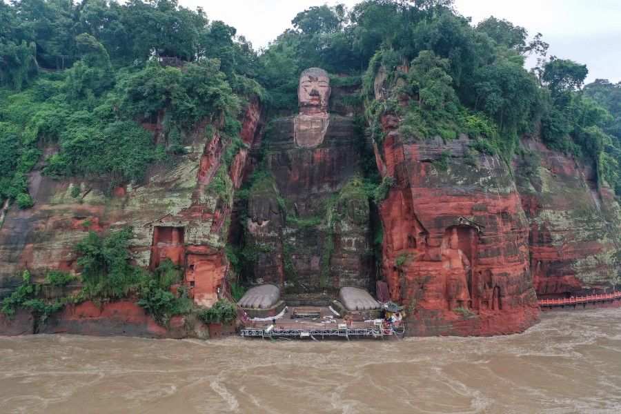 This aerial photo shows the Leshan Giant Buddha surrounded by floodwaters following heavy rains in Leshan in China's southwestern Sichuan province on 19 August 2020. (STR/AFP)