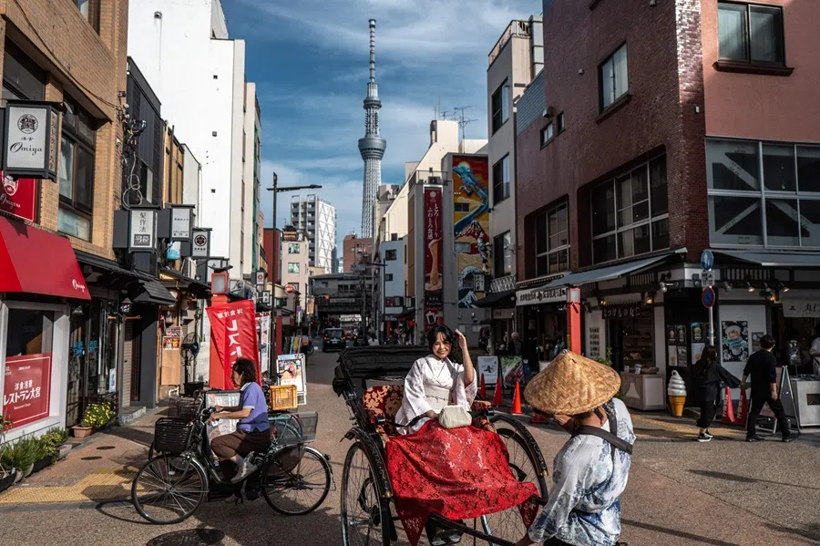 A tourist rides on a rickshaw in Asakusa district in Tokyo on 2 October 2025.