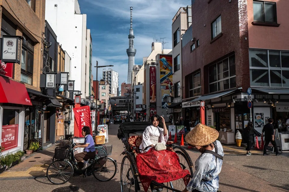 A tourist rides on a rickshaw in Asakusa district in Tokyo on 2 October 2025. (Philip Fong/AFP)