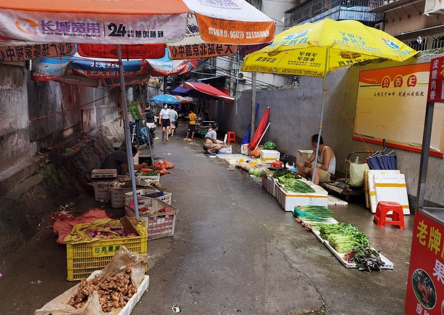Vendors sell vegetables at street stalls, in Guangzhou's Xiaobei neighbourhood, Guangdong province, China, 17 June 2020. (David Kirton/Reuters)