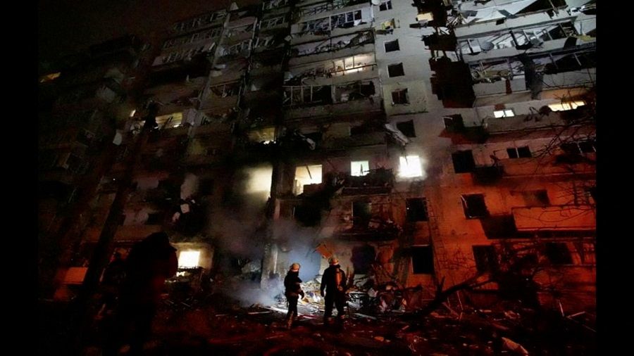 Firefighters work at the site of a damaged residential building, after Russia launched a massive military operation against Ukraine, in Kyiv, Ukraine, 25 February 2022 in this frame grab of a still image used in a video. (Ukrainian Ministry of Emergencies via Reuters TV/Handout)