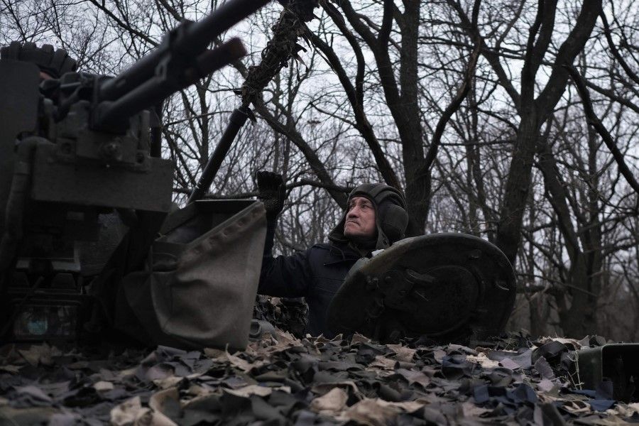 A Ukrainian serviceman of the "Adam" tactical group looks on as he prepares a T-64 tank to move to the positions on the front line near Bakhmut, on 19 March 2023, amid the Russian invasion of Ukraine. (Sergey Shestak/AFP)
