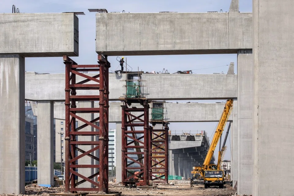 Workers labor at the construction site of an elevated highway on the outskirts of Shanghai, China, 12 June 2020. China's economy continued to recover in May, with accelerating industrial output growth leading the way while consumption remains in contraction. (Qilai Shen/Bloomberg)