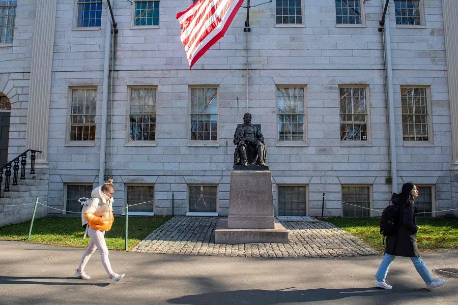 People walk through Harvard Yard at Harvard University in Cambridge, Massachusetts, on 12 December 2023. (Joseph Prezioso/AFP)