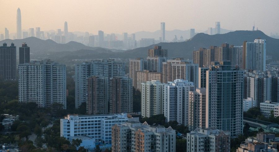 Buildings in Shenzhen on the horizon beyond residential buildings in the Fanling area of Hong Kong, China, 16 February 2021. (Billy H.C. Kwok/Bloomberg)