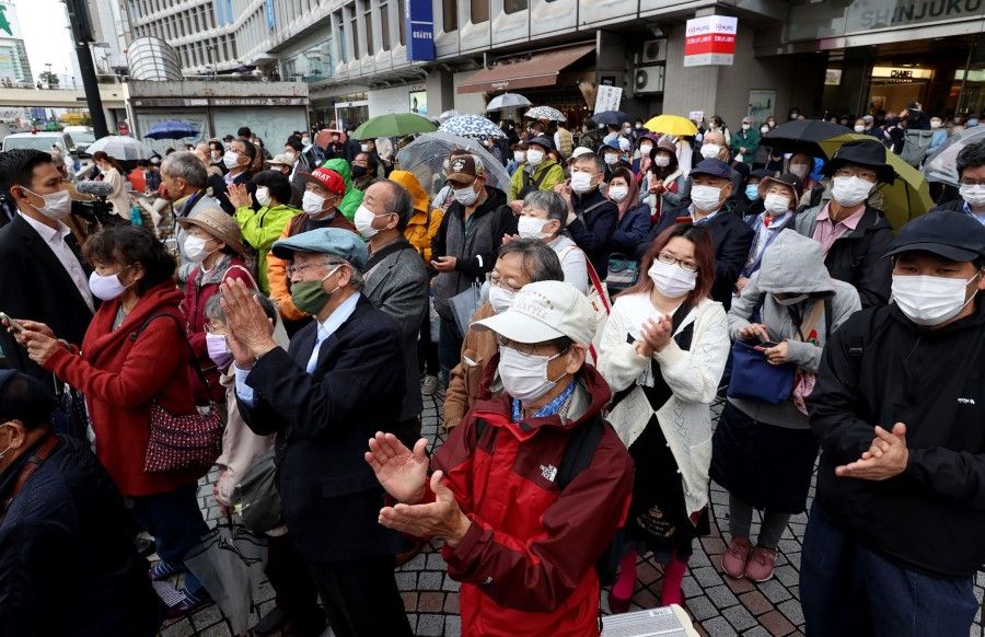 People gather as they an election campaign in Tokyo on 19 October 2021 on the first day of campaigning for Japan's upcoming general election. (STR/Jiji Press/AFP)