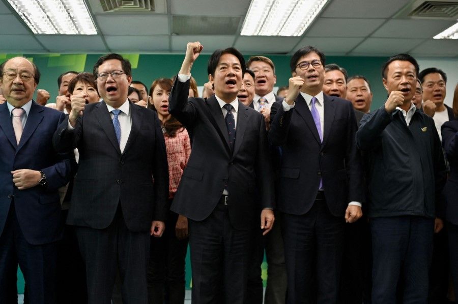 Taiwan Vice-President and chairman of ruling Democratic Progressive Party (DPP) William Lai (third from left) gestures following his speech at the DPP headquarters in Taipei on 12 April 2023. (Sam Yeh/AFP)