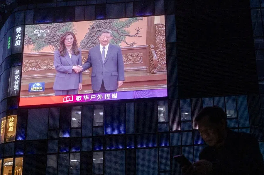 A giant screen broadcasts news showing Chinese President Xi Jinping shaking hands with Cheng Li-wun, KMT chair, at the Great Hall of the People in Beijing, China, 10 April 2026. (Maxim Shemetov/Reuters)