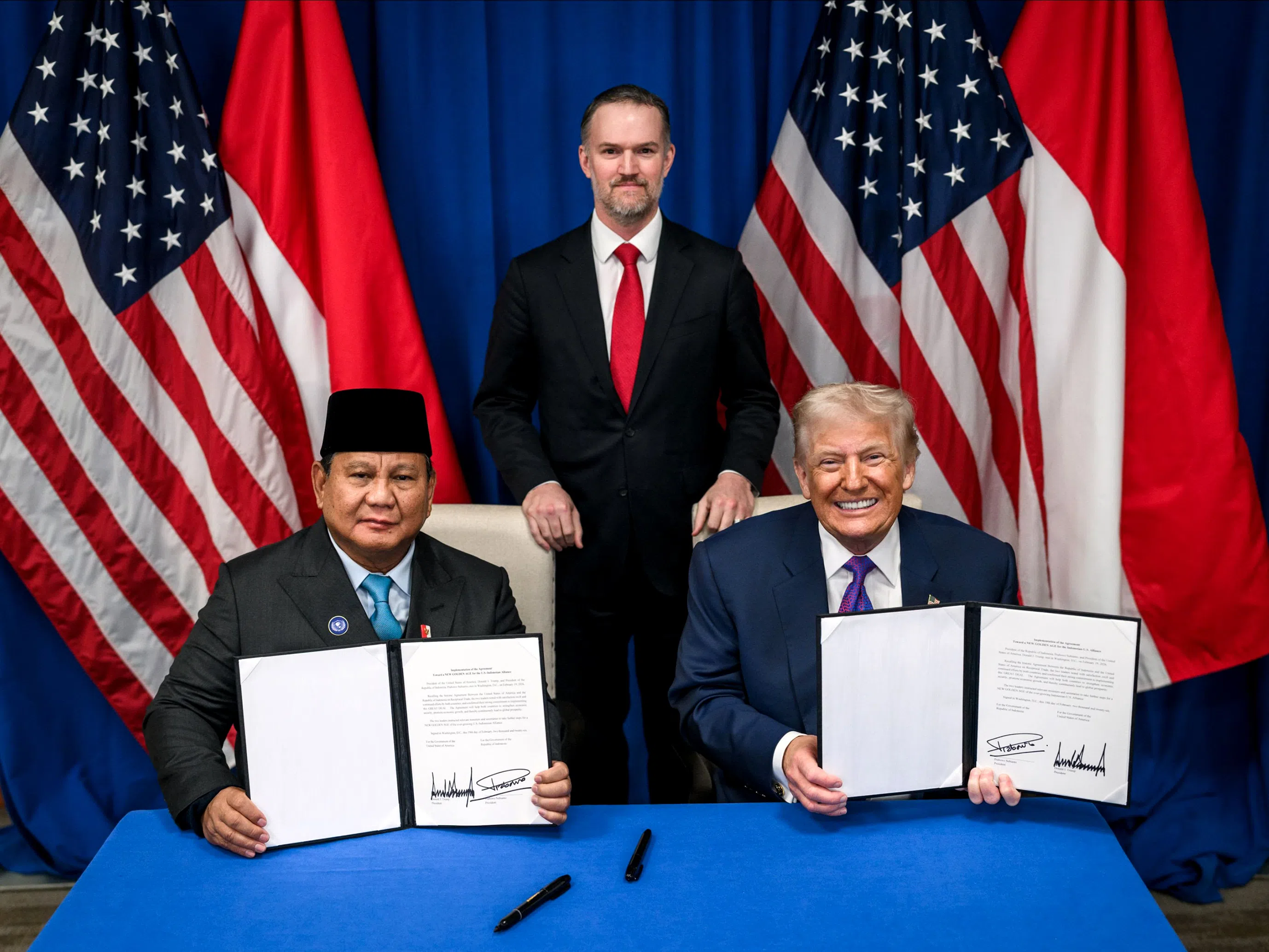 Indonesian President Prabowo Subianto (left) and US President Donald Trump (right) sign a joint statement regarding the recently signed United States-Indonesia Agreement on Reciprocal Trade in Washington DC, on 19 February 2026.