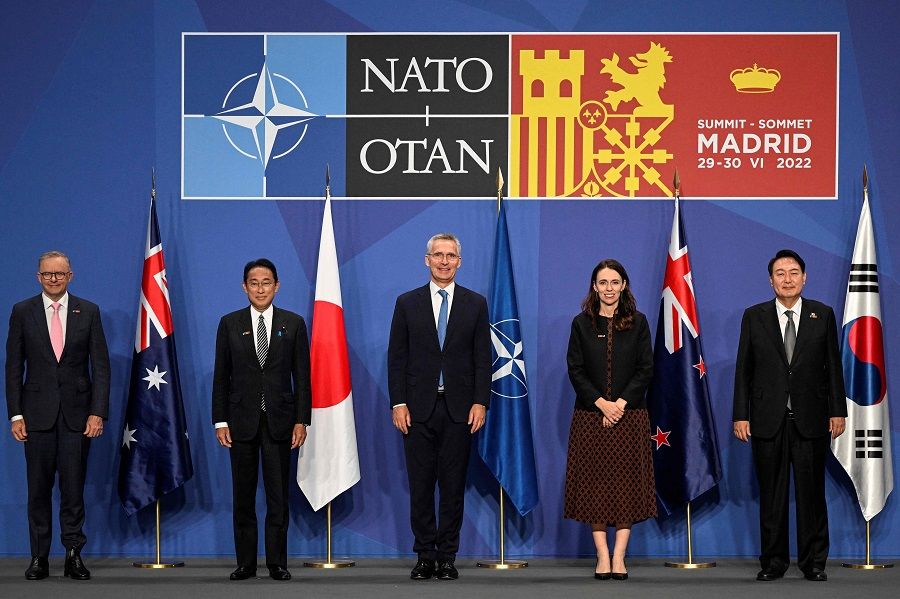 (left to right) Australia's Prime Minister Anthony Albanese, Japan's Prime Minister Fumio Kishida, NATO Secretary-General Jens Stoltenberg, New Zealand Prime Minister Jacinda Ardern and South Korea's President Yoon Suk-yeol pose for a group photograph ahead of an Indo-Pacific Partners meeting during the NATO summit at the IFEMA congress centre in Madrid, Spain, on 29 June 2022. (Pierre-Philippe Marcou/AFP)