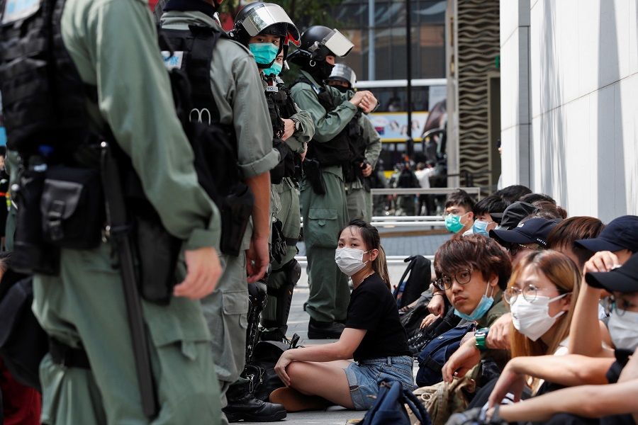 Anti-government demonstrators are detained by riot police during a protest at Causeway Bay in Hong Kong, China, on 27 May 2020. (Tyrone Siu/Reuters)