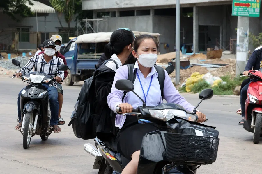 People ride motorbikes on a street in Sihanoukville. (Kwong Kai Chung/SPH Media)