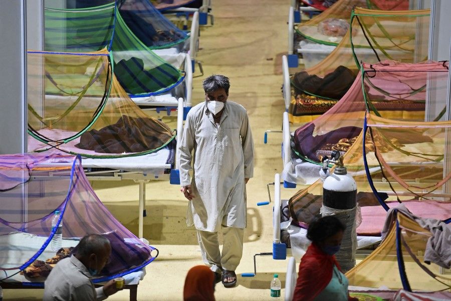 Patients who have tested positive for Covid-19 are seen inside a centre of the Commonwealth Games (CWG) village which has been temporarily converted into a Covid care facility in New Delhi on 2 May 2021. (Tauseef Mustafa/AFP)