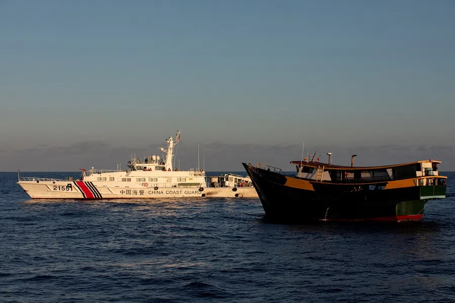 A Chinese Coast Guard vessel blocks the Philippine resupply vessel Unaizah May 4, on its way to a resupply mission at Second Thomas Shoal in the South China Sea, on 5 March 2024. (Adrian Portugal/Reuters)