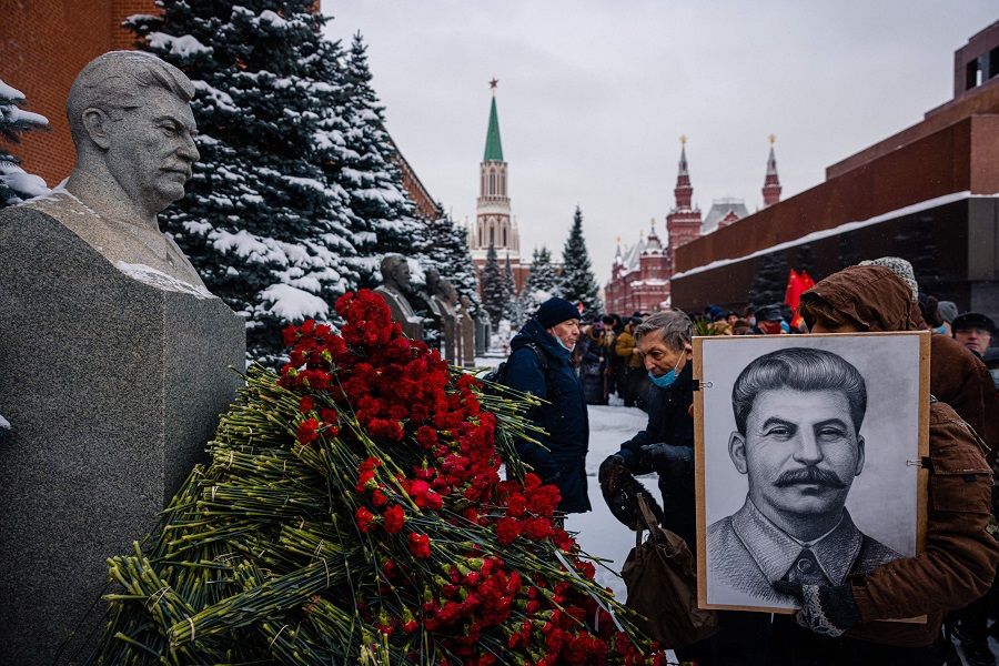 Russian Communist party supporters lay flowers to the tomb of late Soviet leader Joseph Stalin during a memorial ceremony to mark the 142nd anniversary of his birth at Red Square in Moscow on 21 December 2021. (Dimitar Dilkoff/AFP)