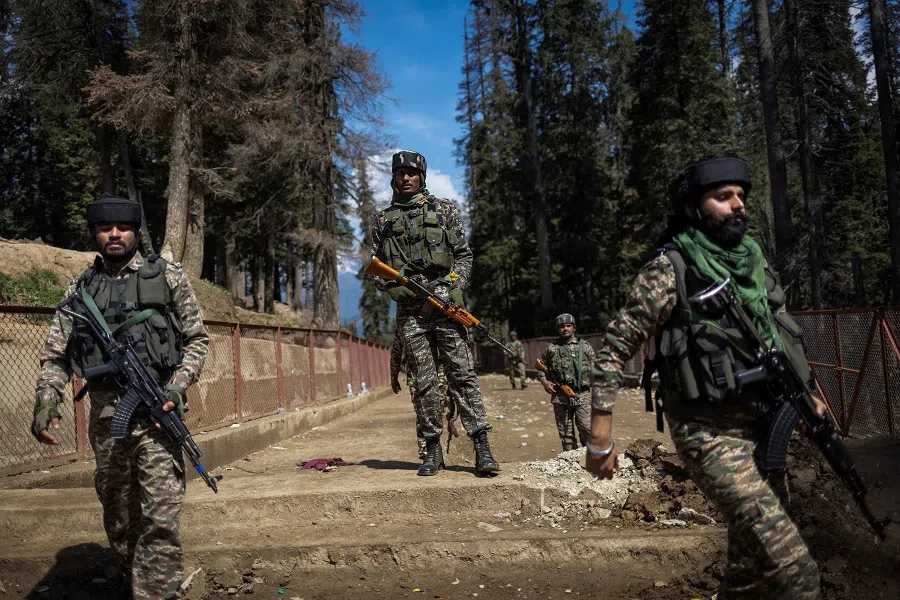 Indian security force personnel stand guard at the site of a suspected militant attack on tourists in Baisaran near Pahalgam in south Kashmir’s Anantnag district on 24 April 2025.  (Adnan Abidi/Reuters)