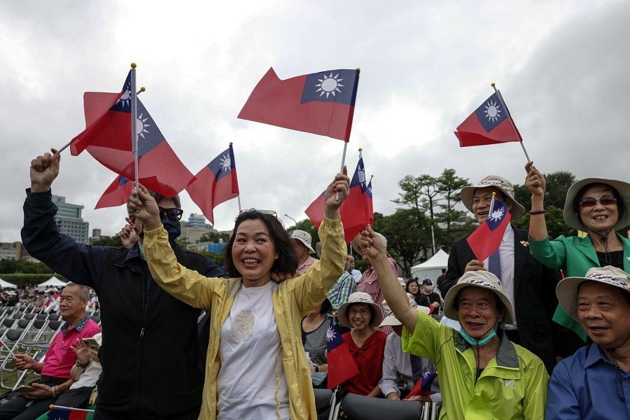 A group of participants cheer as they pose for a photo during the Double Ten Day celebration in Taipei, Taiwan, on 10 October 2023. (I-Hwa Cheng/Bloomberg)