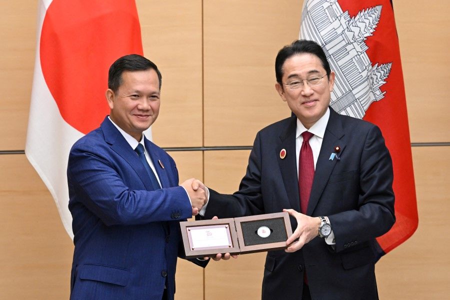 Japan's Prime Minister Fumio Kishida presents Cambodia's Prime Minister Hun Manet with a Cambodian commemorative silver coin made at the Japanese Mint to celebrate the 70th anniversary of diplomatic relations between Cambodia and Japan, at the prime minister's official residence in Tokyo on 18 December 2023. (Kazuhiro Nogi/Reuters)