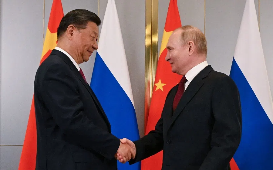 In this pool photograph distributed by the Russian state agency Sputnik, Russia’s President Vladimir Putin meets with China’s President Xi Jinping on the sidelines of the Shanghai Cooperation Organisation (SCO) member states leaders’ summit in Astana on 3 July 2024. (Sergei Guneyev/Pool/AFP)