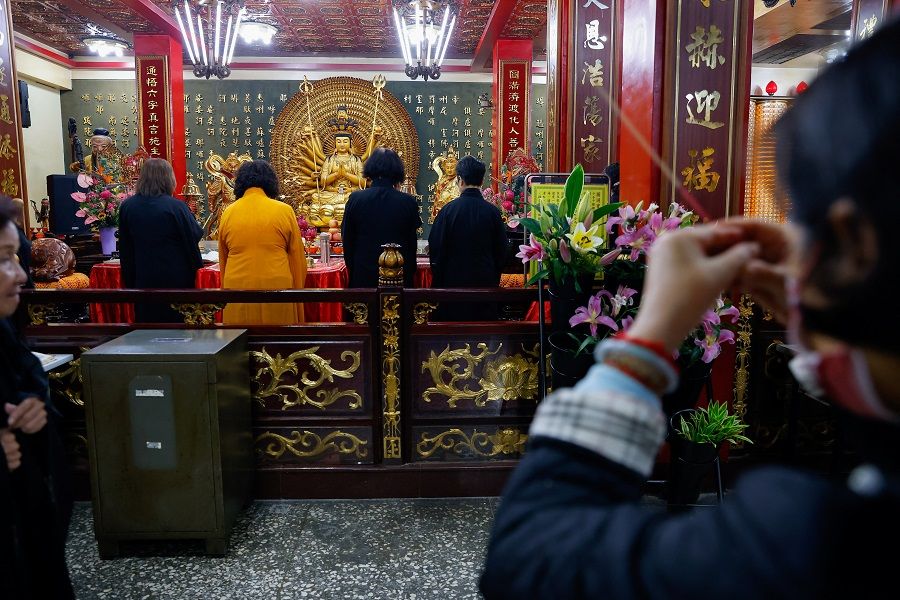 People pray at a temple in New Taipei City, Taiwan, on 29 October 2023. (Ann Wang/Reuters)