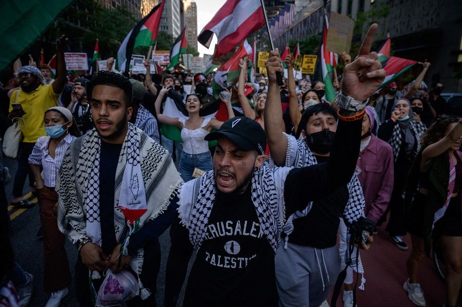 Demonstrators shout slogans and wave flags as they march during an 'emergency rally to defend Palestine' in Manhattan, New York, US on 15 June 2021. (Ed Jones/AFP)
