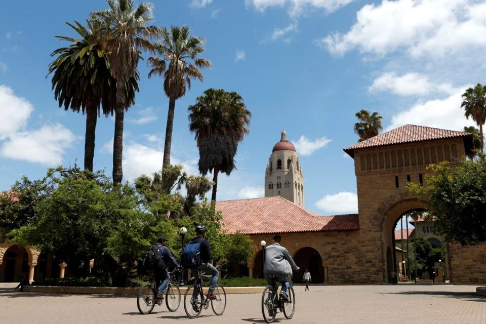Cyclists traverse the main quad on Stanford University's campus in Stanford, California, US, on 9 May 2014. (Beck Diefenbach/Reuters)