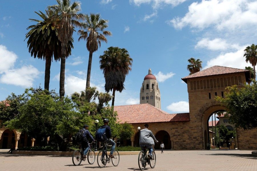 Cyclists traverse the main quad on Stanford University's campus in Stanford, California, US, on 9 May 2014. (Beck Diefenbach/Reuters)