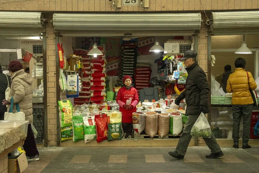 A vendor at a wholesale grains market in Shanghai, China, on 4 March 2025. (Raul Ariano/Bloomberg)