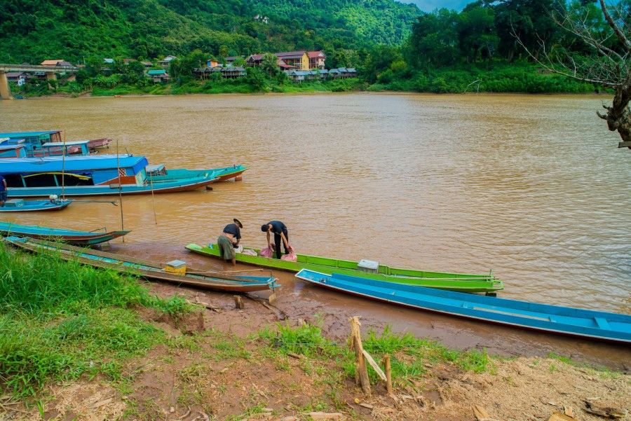 A local villager working on a boat on the Nam Ou River from the village of Nong Khiaw in Laos. (iStock)