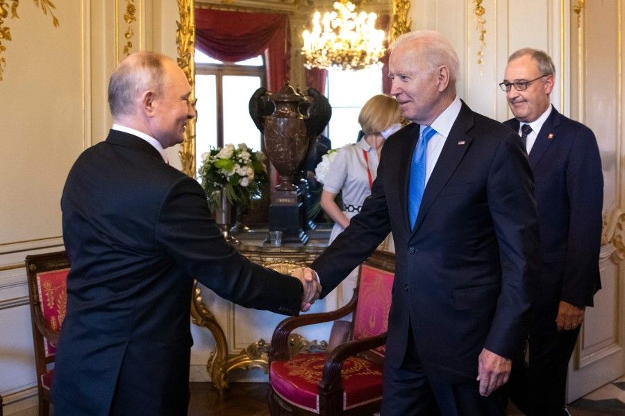 US President Joe Biden (centre) shakes hands with Russian President Vladimir Putin (left) prior to the US-Russia summit at the Villa La Grange, in Geneva on 16 June 2021. (Peter Klaunzer/AFP)