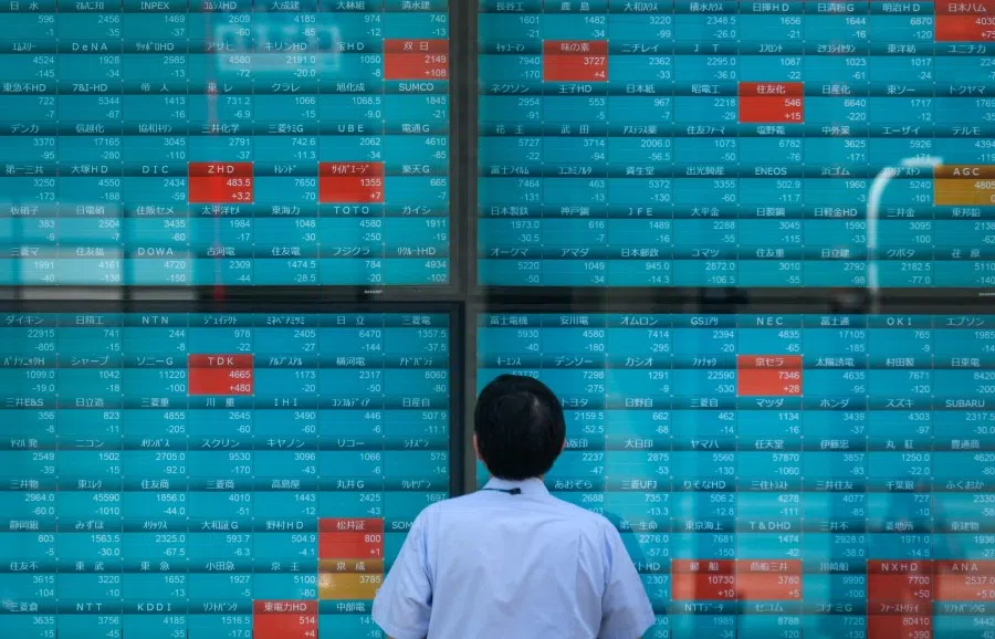 A man looks at an electronic quotation board displaying stock prices on the Tokyo Stock Exchange in Tokyo on 2 August 2022. (Kazuhiro Nogi/AFP)