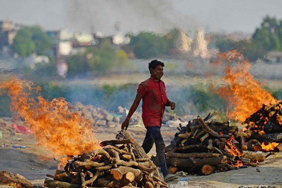 Funeral pyres burn as the last rites are performed of the patients who died of the Covid-19 coronavirus at a cremation ground in Allahabad, India, on 27 April 2021. (Sanjay Kanojia/AFP)