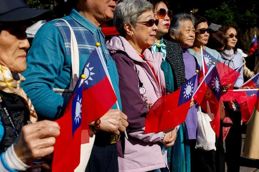 People hold Taiwan flags at an event where Cheng Li-wun, the chairwoman of Kuomintang, makes a speech in Taipei, Taiwan, on 12 March 2026. (Ann Wang/Reuters)