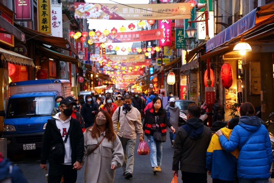 People on a street in Taipei, Taiwan, 30 January 2022. (Ann Wang/Reuters)
