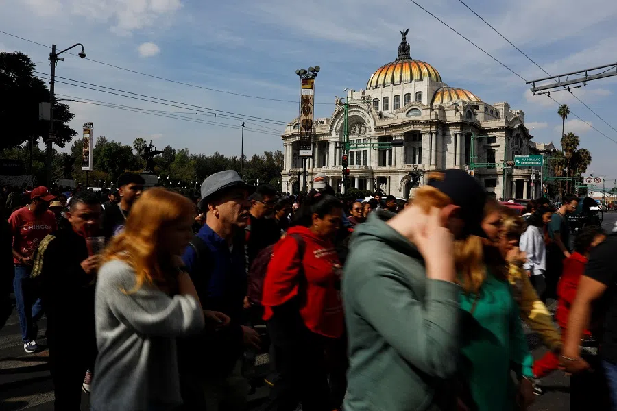 Pedestrians cross a street near the Palacio de Bellas Artes, or Palace of Fine Arts, in downtown Mexico City, Mexico, on 21 December 2024. (Tomas Bravo/Reuters)