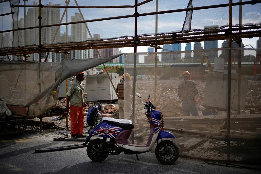Workers work at a demolition site, following the Covid-19 outbreak, in Shanghai, China, 9 September 2022. (Aly Song/Reuters)